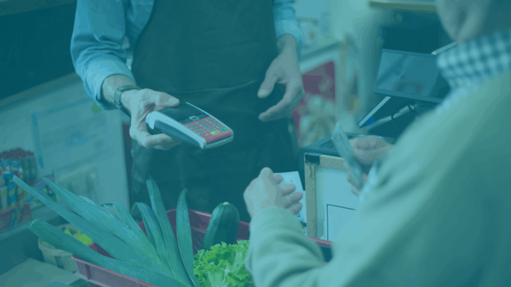 Money is exchanged at a grocery store